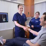 Dr. Howard shaking male patients hand