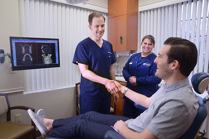 Dr. Howard shaking male patients hand