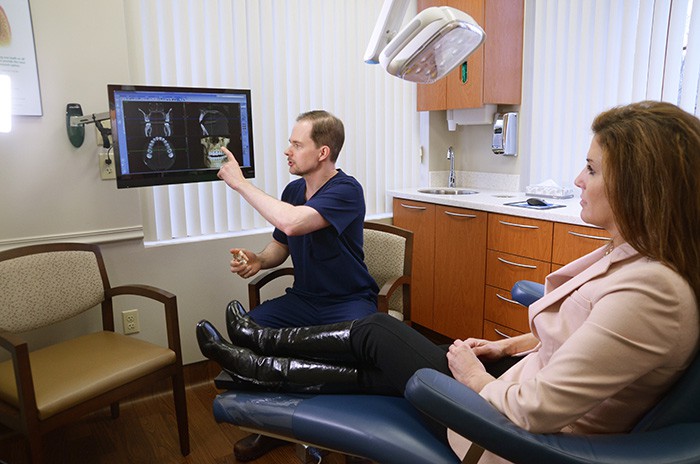 Dr. Howard pointing to x ray with female patient